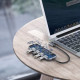 Baseus CAHUB-EZ0G Multi-functional Hub connecting a phone and MacBook for seamless data transfer and charging