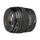 Canon EF 85mm f 1.8 USM lens displayed on a wooden surface, showcasing its design and features